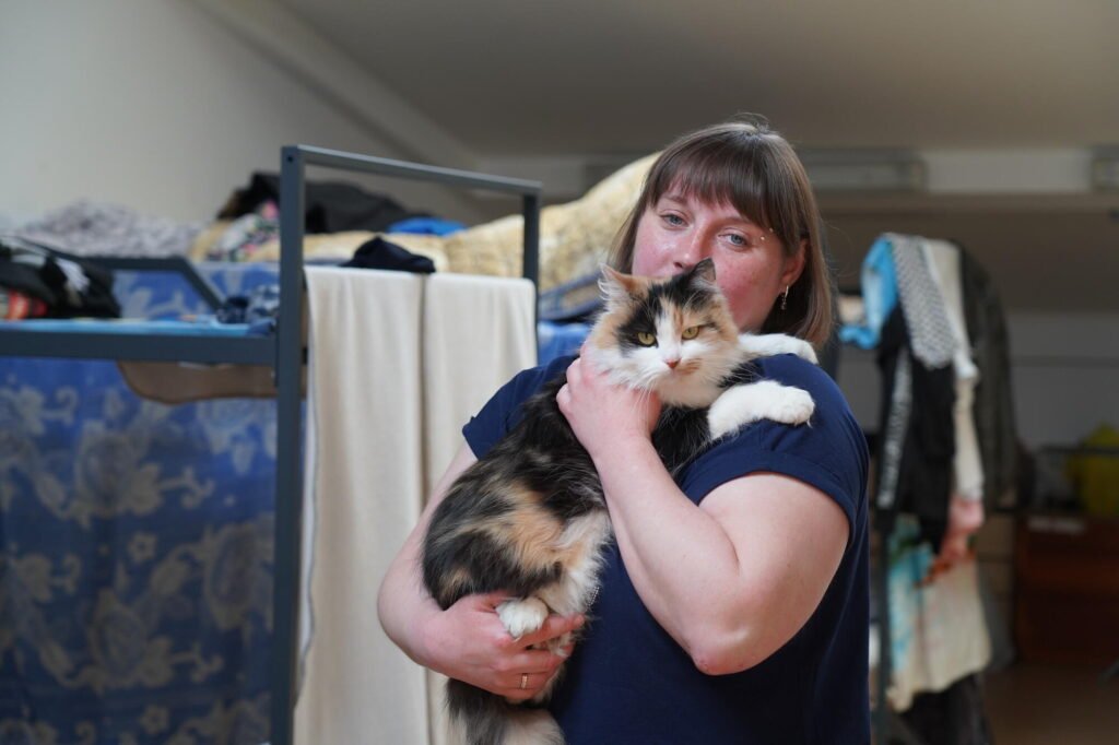 Ukrainalainen Anstasiia pitää kissaa sylissä.